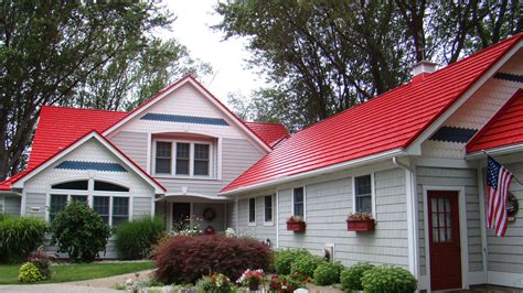 red house with green metal roof|homes with red metal roofs.